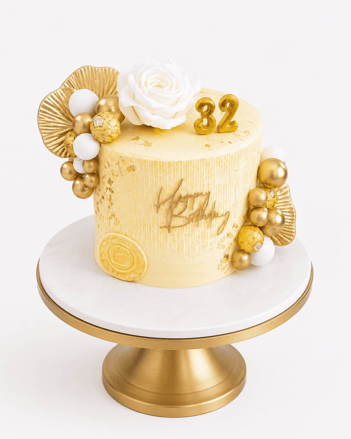 Gold and cream birthday cake with Ferrero Rocher and a white rose by Glory Treats