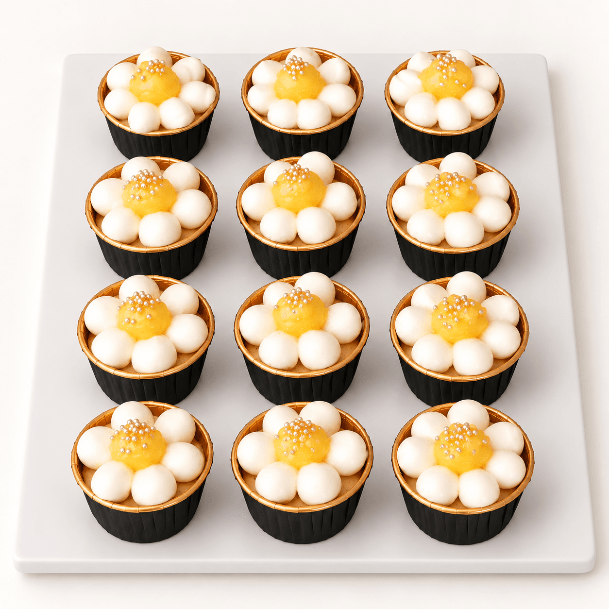 Lemon cupcakes with a white and gold daisy topper by Glory Treats