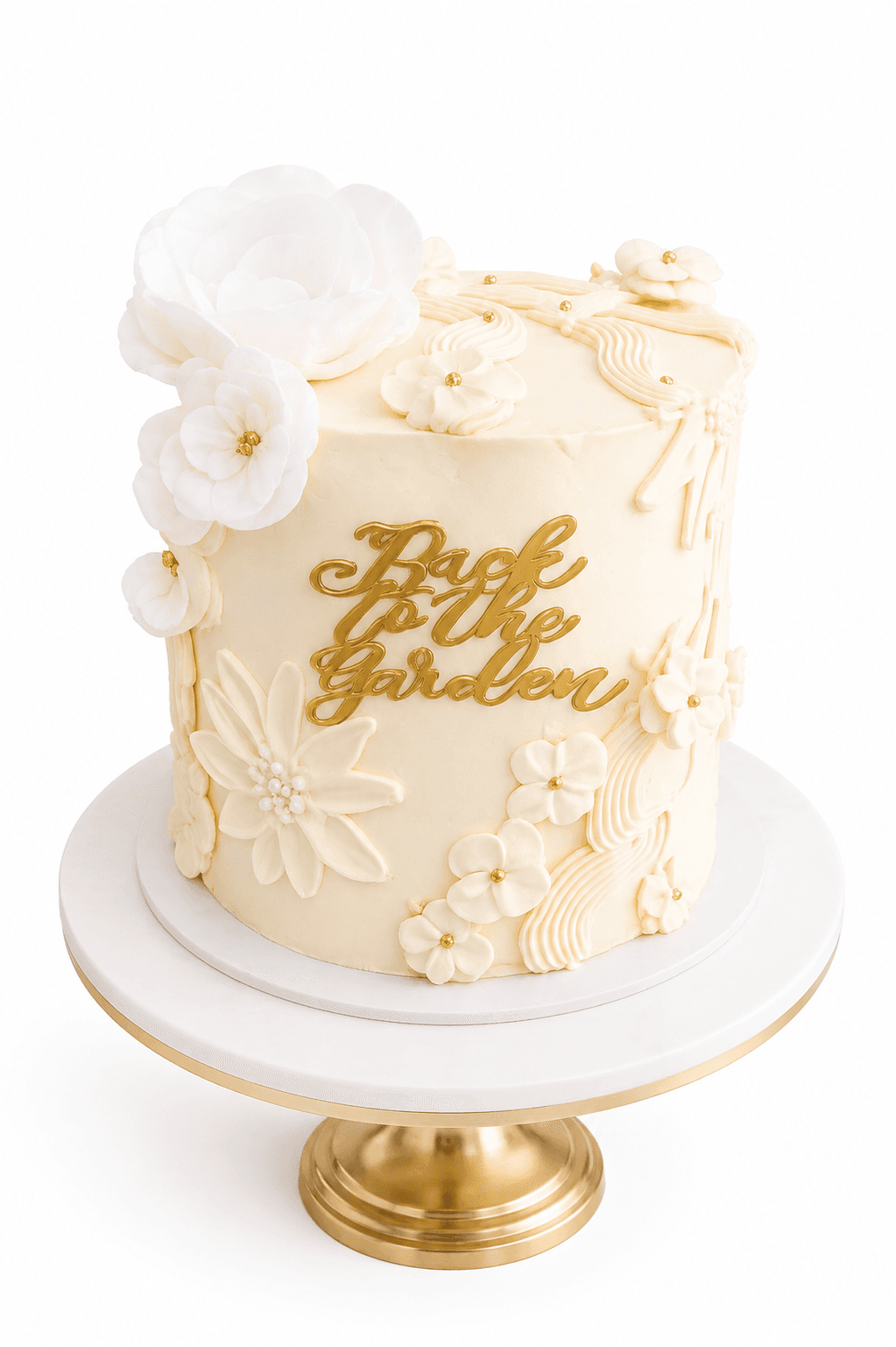 Ivory floral celebration cake with a gold 'Back to the Garden' topper by Glory Treats