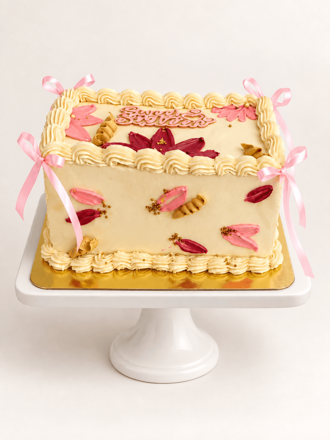 Ivory rectangle Sweet Sixteen cake with hand-painted florals and pink ribbons by Glory Treats