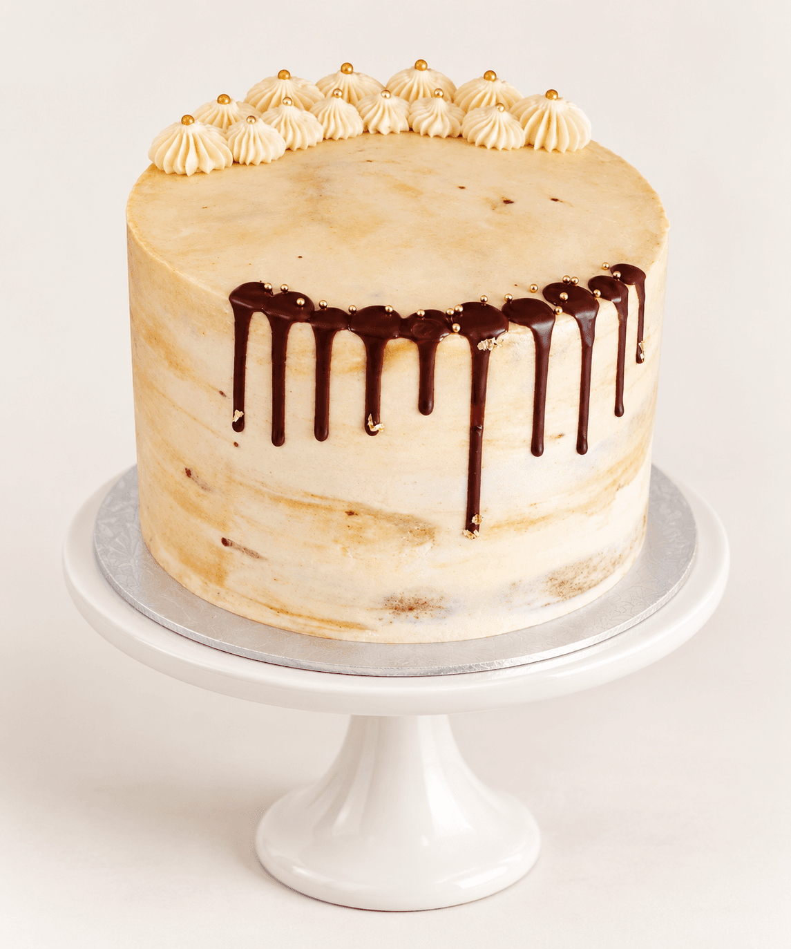 Chocolate drip cake with gold beads and gold leaf by Glory Treats