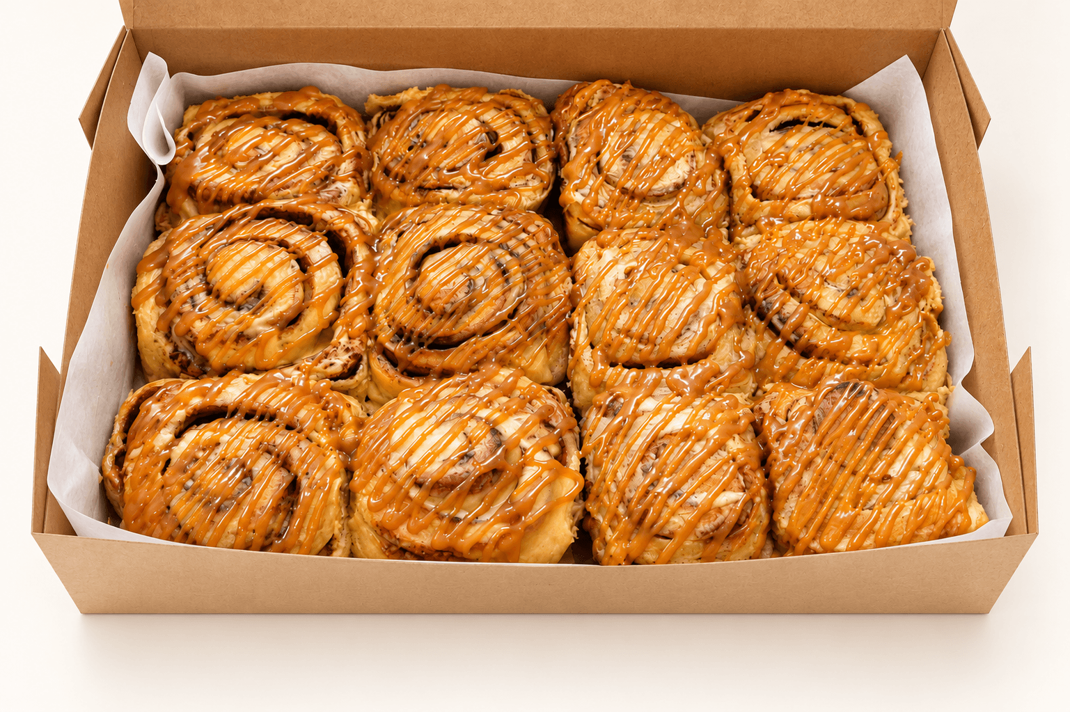 A dozen caramel cinnamon rolls by Glory Treats